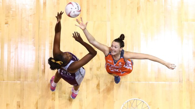 Romelda Aiken of the Firebirds and Sam Poolman of the Giants compete for the ball during their round eight Super Netball clash.