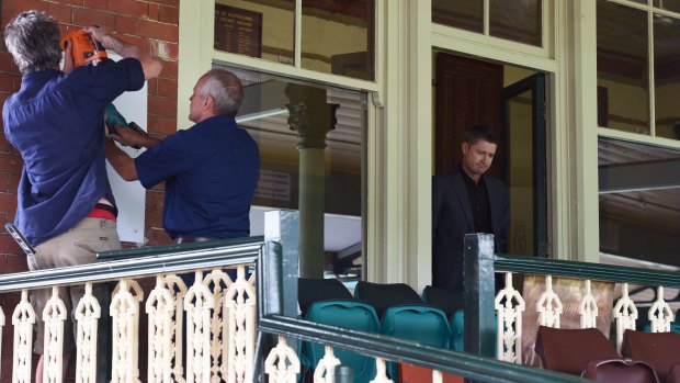 Michael Clarke stands by as the plaque for Phillip Hughes is put up at the SCG.