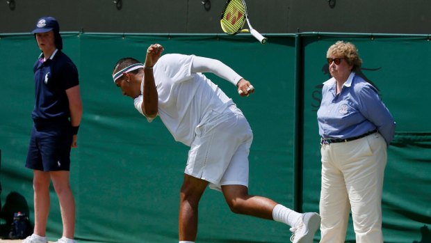 Feet of clay: Nick Kyrgios hurls his racquet to the ground during his match against Milos Raonic at Wimbledon.