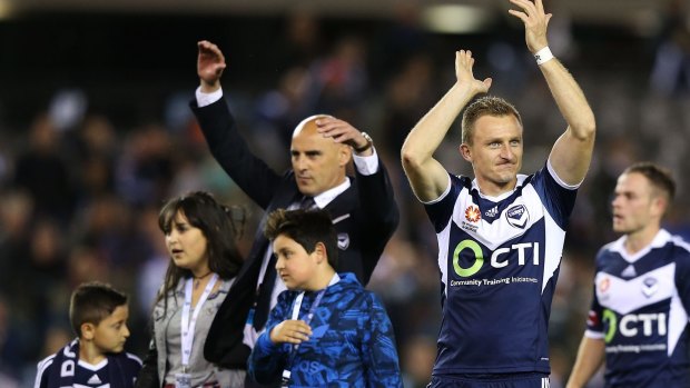 Melbourne Victory coach Kevin Muscat celebrates with his children and Besart Berisha after the game.