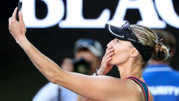 Candid and on camera: Croatia's Mirjana Lucic-Baroni takes a selfie on her phone as she leaves Rod Laver Arena.
