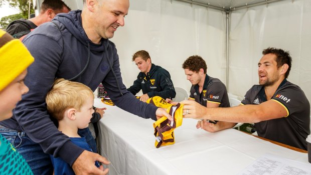 Luke Hodge and his teammates signs autographs for fans at family day.