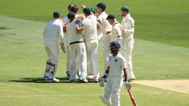 The Aussies celebrate the wicket of Shikhar Dhawan.