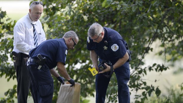 Chicago Police investigators collect evidence while searching a park after a toddler's decomposed feet and hand were found in a lagoon.