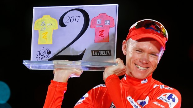Britain's Chris Froome celebrates on podium after winning the Vuelta, having also won this year's Tour de France.