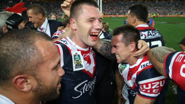 Grand final hero: Shaun Kenny-Dowall, with a broken jaw, celebrates with his Roosters teammates after the 2013 grand final.