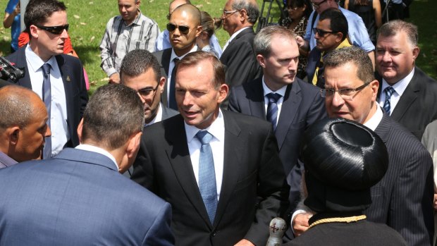 Among the throng: Tony Abbott treading lightly at yesterday's media briefing.