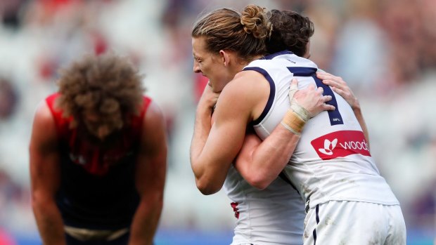 Alive and kicking: Nat Fyfe and Lachie Neale celebrate a big win over Melbourne.
