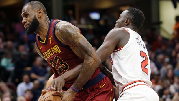 Cleveland Cavaliers' LeBron James (left) is fouled by Chicago Bulls' Jerian Grant.