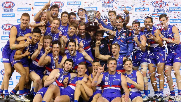 Footscray players celebrate with the premeirship cup after winning the VFL grand final against Box Hill on Sunday.