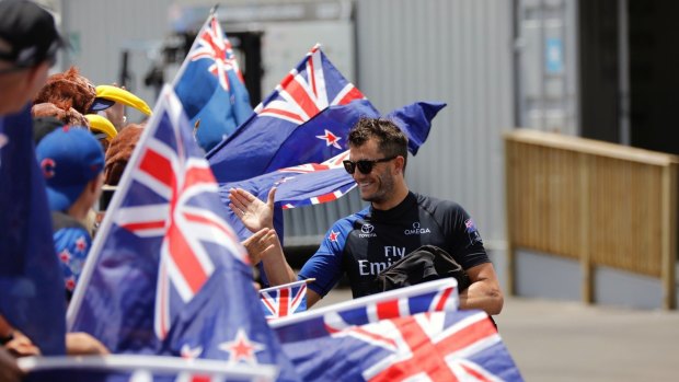 A Kiwi crew member from  greeting fans before the America's Cup sailing event on Monday.