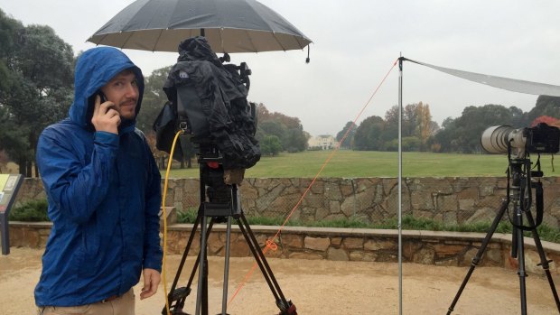 A wet and cold channel 9 cameraman wishes his mother Happy Mother's day while staking out Government House ahead of the expected arrival of Prime Minister Malcolm Turnbull.