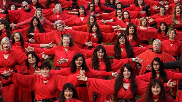 Hundreds of people put on red dresses for Melbourne's Most Wuthering Heights Day Ever in Edinburgh Gardens.