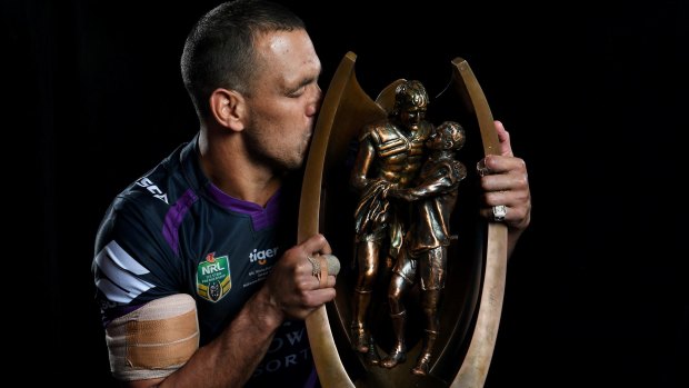 To the victor go the spoils: Will Chambers shares a moment with the NRL trophy after the grand final.