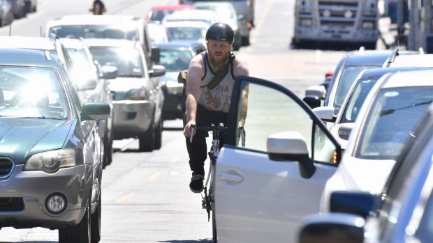 A cyclist makes his way along Sydney Road in Brunswick. 