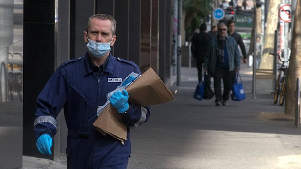 A forensic officer enters the Oaks on Market. 