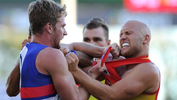 GOLD COAST, AUSTRALIA - MAY 25: Gary Ablett of the Suns and Jake Stringer of the Bulldogs wrestle during the round 10 AFL match between the Gold Coast Suns and the Western Bulldogs at Metricon Stadium on May 25, 2014 on the Gold Coast, Australia.  (Photo by Matt Roberts/Getty Images)