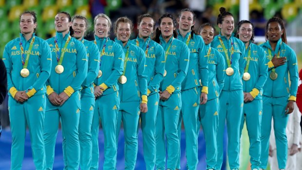 Winners: The Australian women's sevens team accept their gold medals in Brazil.