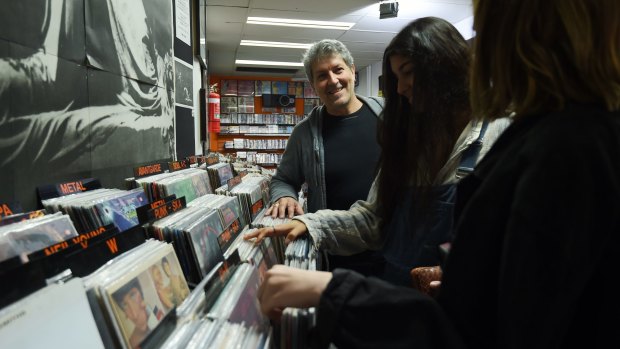 Baz Scott (left), the owner of Egg Records in Newtown, talks to customers Breanne Woods (centre)  and Ciara Rogers, both 16. 