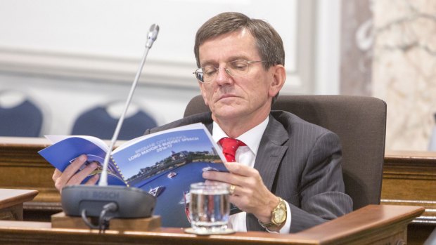 Brisbane council opposition leader Peter Cumming reads the 2016-17 budget in the council chamber.