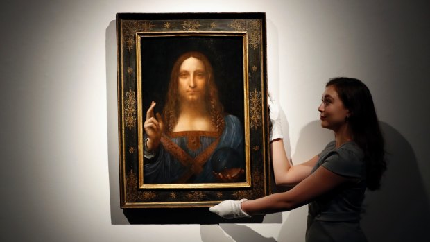 An employee with Leonardo da Vinci's Salvator Mundi  on display at Christie's auction rooms, in London.