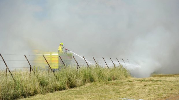 Fire crews put out a small grass fire on majura road near the airport in November 2014. 
