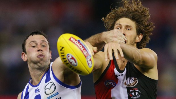 Tom Hickey of the Saints and Todd Goldstein of the Kangaroos compete for the ball in the ruck.