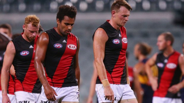 Reality check: Brendon Goddard leads the Bombers off after their loss to West Coast.