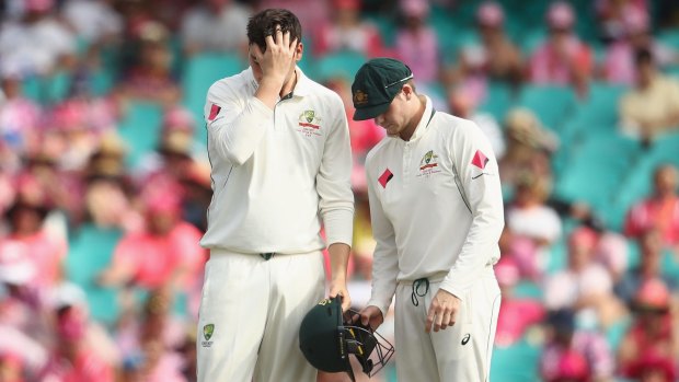 Second knock: Matt Renshaw with Australia skipper Steve Smith after being hit on the helmet while fielding on Thursday.