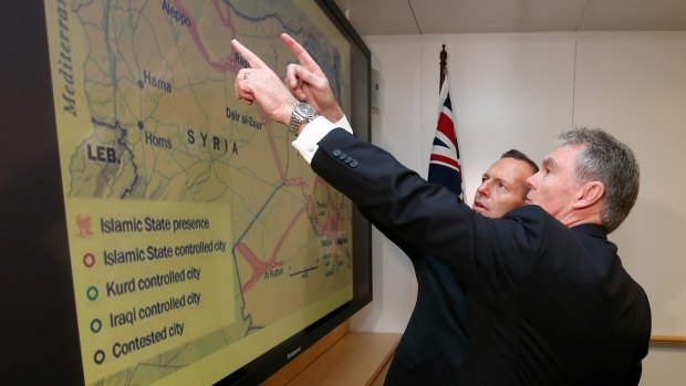 ASIO director-general Duncan Lewis gives a briefing to then prime minister Tony Abbott in June.