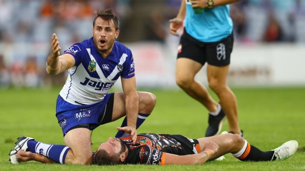 Josh Reynolds of the Bulldogs shows concern for his NSW Origin teammate Robbie Farah of the Tigers.