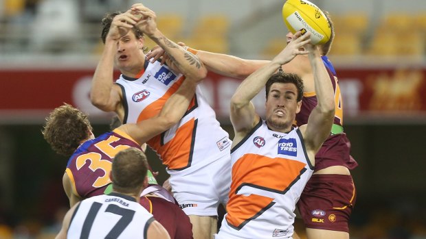Giants' Jeremy Cameron takes a mark to score one of three goals on Sunday night at the Gabba.