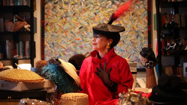 Fiery finery: Alison Waters poses for a photo with her extraordinary hat collection.