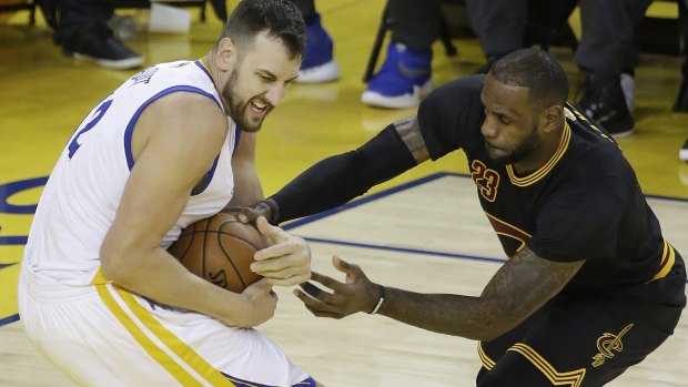 Golden State Warriors centre Andrew Bogut defends against Cleveland Cavaliers forward LeBron James, right, in game five.