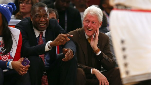 Friends in high places: Dikembe Mutombo talks with former president Bill Clinton during the 2015 NBA All-Star Game at Madison Square Garden.