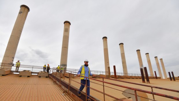 Power station worker Dale Foster walks across the roof of the Hazelwood power station.