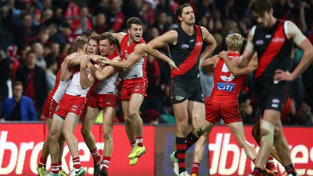 Bombed: Gary Rohan is mobbed by Sydney teammates after booting the winning goal.