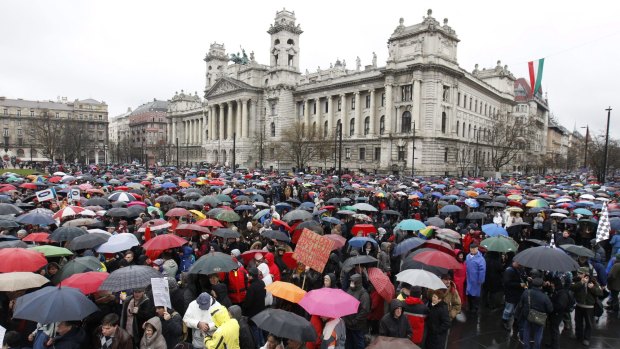 Thousands of people, their checked shirts obscured, demand the reconstruction of the Hungarian public education system outside Parliament in Budapest on March 15.