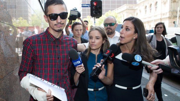 Reporters surround Angelo Gargasoulas after he leaves the Melbourne Magistrates Court.