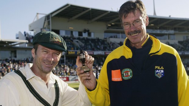 John Buchanan holding an Ashes urn replica with former Test captain Steve Waugh at the WACA in 2002.