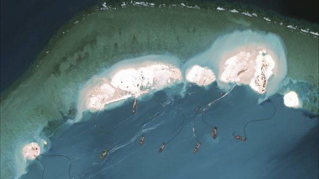 A satellite image shows Chinese dredges working at the northernmost reclamation site of Mischief Reef, part of the Spratly Islands, in the South China Sea, in March. 