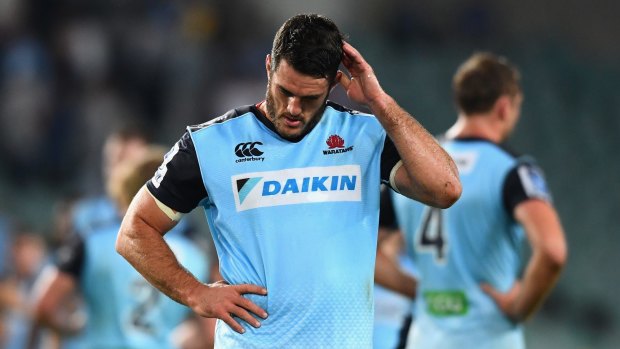 Dejected: David Dennis comes to terms with the loss to the Brumbies on Saturday night.