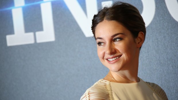 Actress Shailene Woodley poses for photographers upon arrival at a central London cinema for the world premiere of "Insurgent".