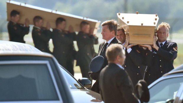 Dutch military carry coffins containing MH17 victims at Eindhoven Airbase.