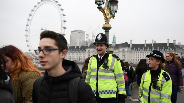 Police officers patrol on Westminster Bridge on Friday in London.