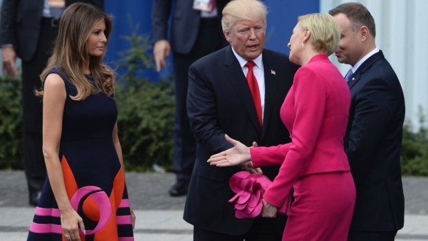 Oops: Poland's first lady Agata Kornhauser-Duda, second right, extends her hand to US first lady Melania Trump as US President Donald Trump reaches his hand for a handshake after his speech in Krasinski Square. On the right is Polish President Andrzej Duda.