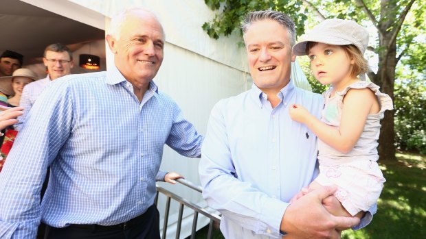 Holding fast: Malcolm Turnbull and Cormann during Family Day at The Lodge.