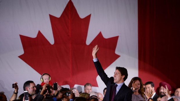 Liberal leader Justin Trudeau makes his way to the stage with wife Sophie Gregoire at the Liberal party headquarters in Montreal on Tuesday.