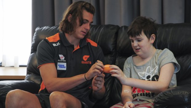 GWS Giants onballer Jack Steele hangs out with James Hehir at Ronald McDonald House.