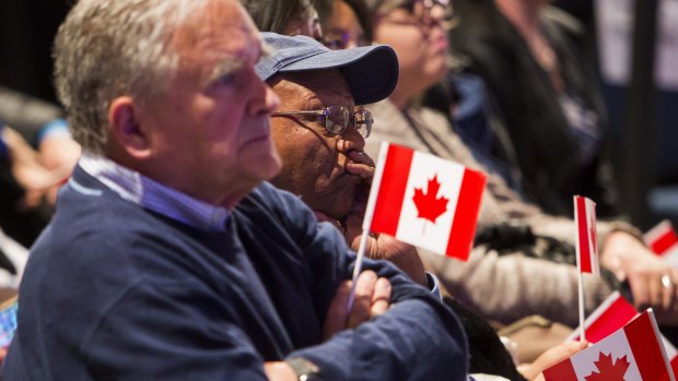 Supporters of Conservative Leader Stephen Harper watch the polls as broadcasters project a Liberal Party victory on election day in Calgary, Alberta.